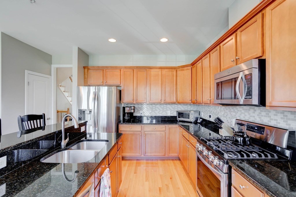 31 Jacob Way, Unit 31 Reading, MA 01867 - Photo 19 of 42 a large kitchen with a large window and stainless steel appliances