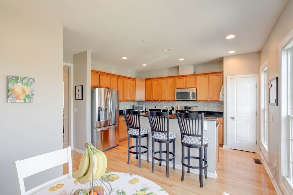 31 Jacob Way, Unit 31 Reading, MA 01867 - Photo 21 of 42 a view of a a dining room with furniture window and wooden floor