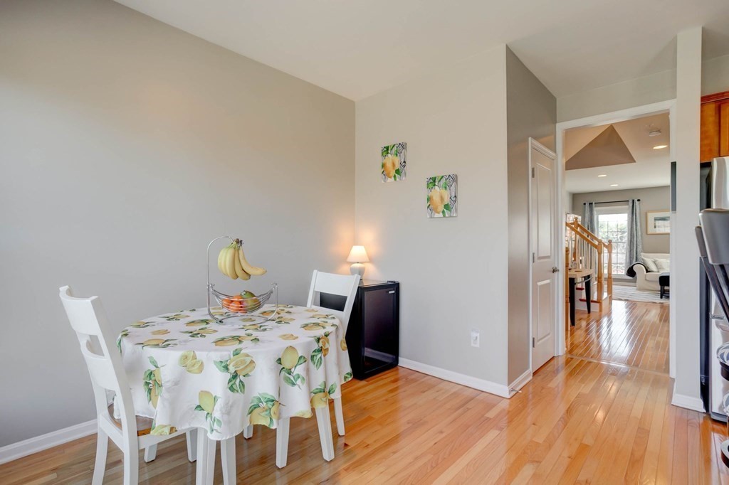 31 Jacob Way, Unit 31 Reading, MA 01867 - Photo 22 of 42 a view of a dining room with furniture and wooden floor