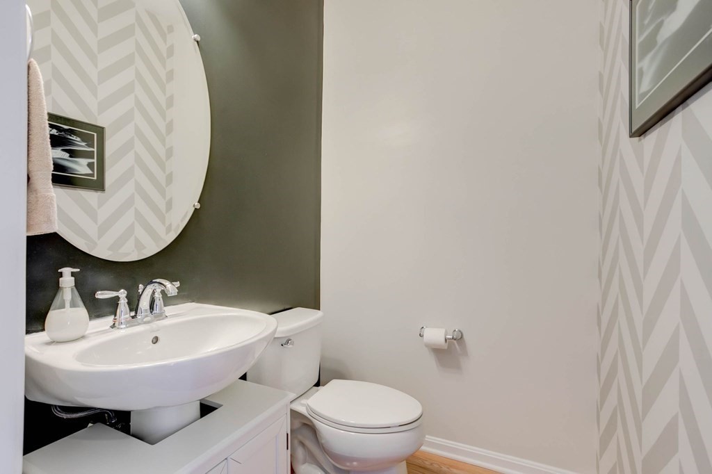 31 Jacob Way, Unit 31 Reading, MA 01867 - Photo 23 of 42 a bathroom with a sink a mirror and toilet