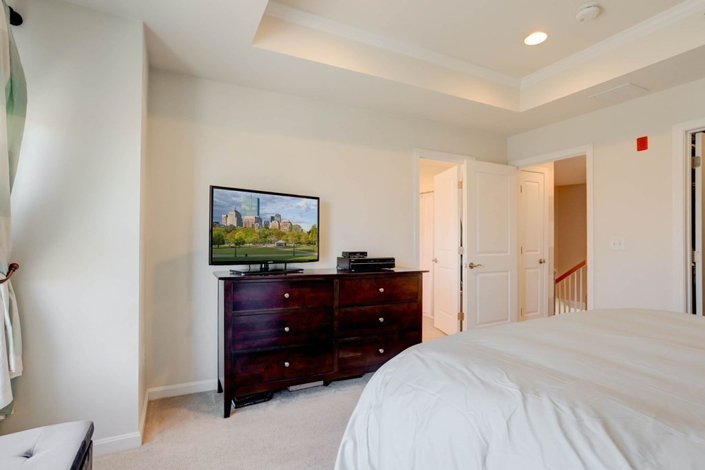 31 Jacob Way, Unit 31 Reading, MA 01867 - Photo 25 of 42 a bedroom with a bed and a dresser