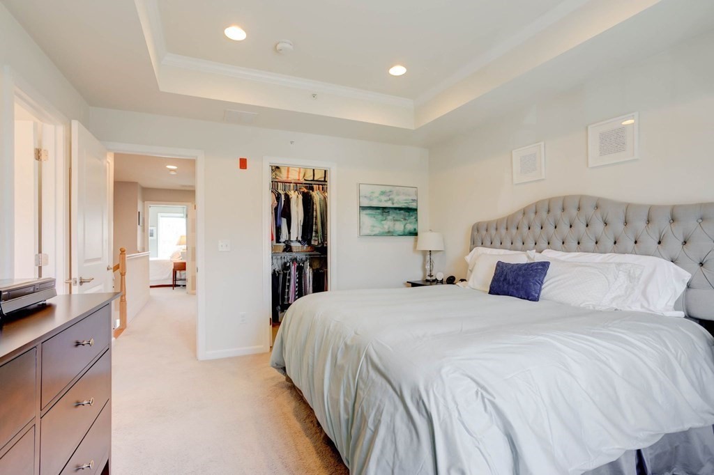 31 Jacob Way, Unit 31 Reading, MA 01867 - Photo 26 of 42 a bedroom with a large bed and a walk in closet