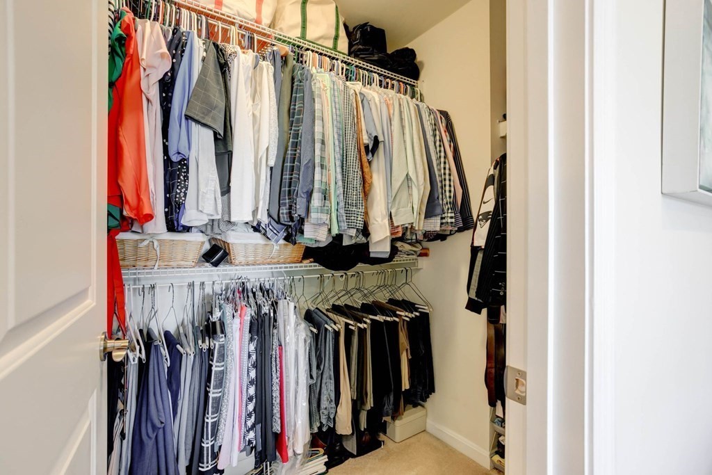 31 Jacob Way, Unit 31 Reading, MA 01867 - Photo 27 of 42 a view of walk in closet with clothes and shoes