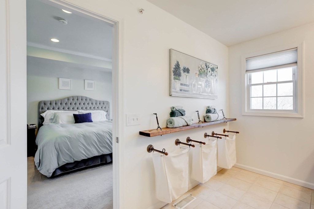 31 Jacob Way, Unit 31 Reading, MA 01867 - Photo 28 of 42 a bedroom with a bed and a table