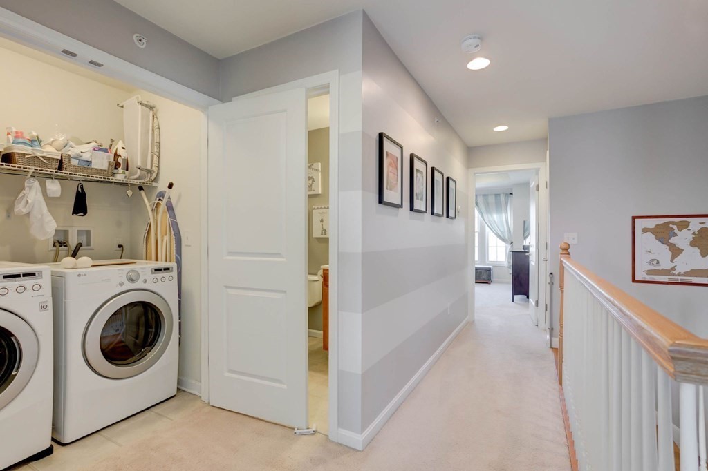 31 Jacob Way, Unit 31 Reading, MA 01867 - Photo 32 of 42 a view of a hallway with washer and dryer