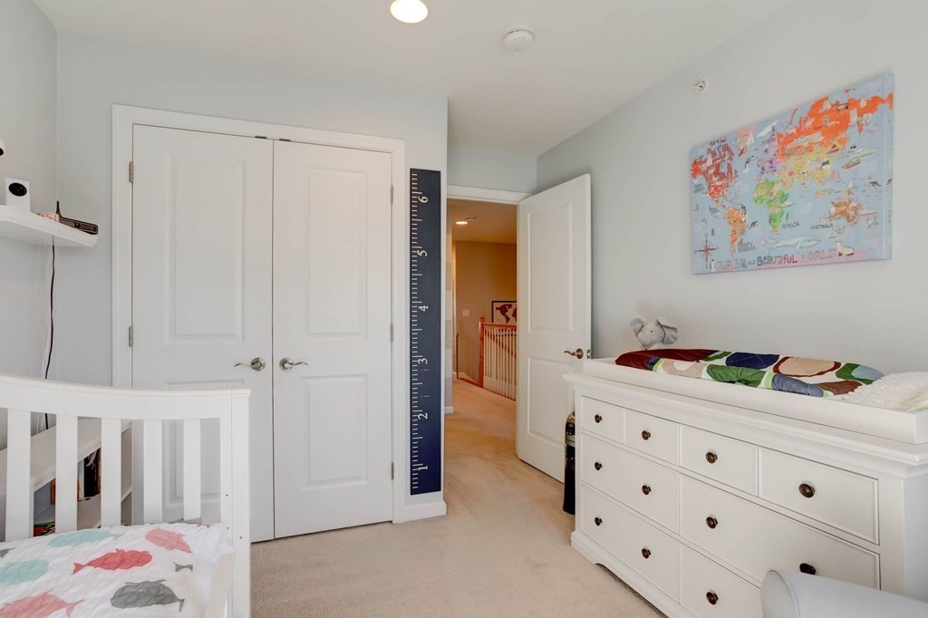 31 Jacob Way, Unit 31 Reading, MA 01867 - Photo 35 of 42 a bedroom with a bed and a dresser in it