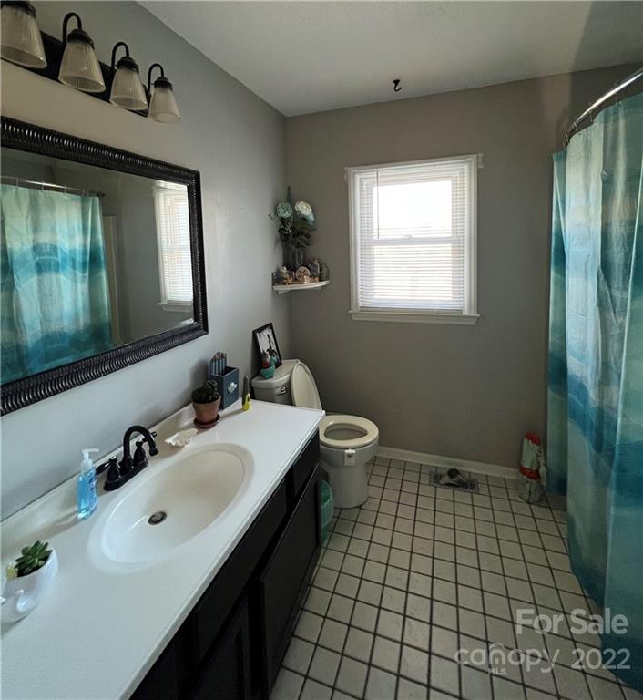 3601 Austin Road Monroe, NC 28112 - Photo 25 of 26 a bathroom with a sink a toilet and mirror