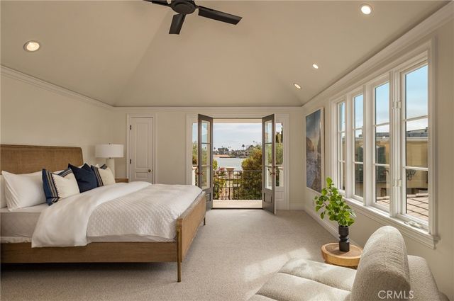 a bedroom with a large bed and a large window