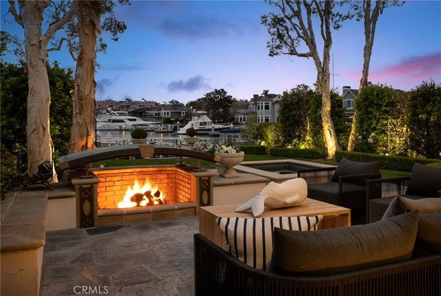 a view of a white house with a yard patio and couches chair