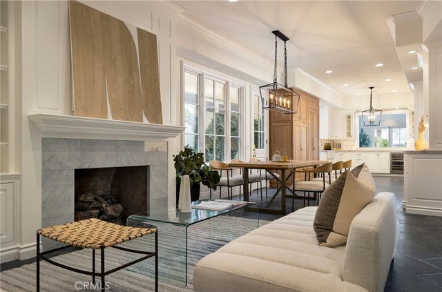 a living room with furniture a fireplace and a chandelier