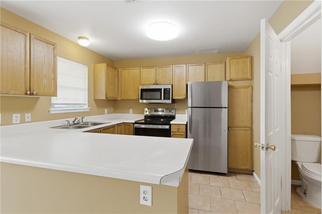 1081 Estes Drive Southwest, Unit 504 Atlanta, GA 30310 - Photo 8 of 32 a kitchen with a refrigerator a stove and a sink