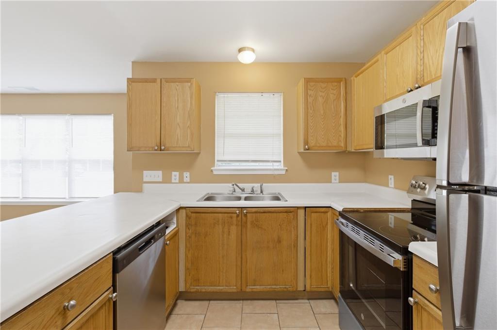 1081 Estes Drive Southwest, Unit 504 Atlanta, GA 30310 - Photo 9 of 32 a kitchen with a sink stove and microwave