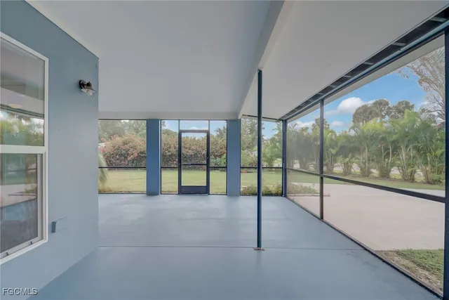 a view of an empty room with windows