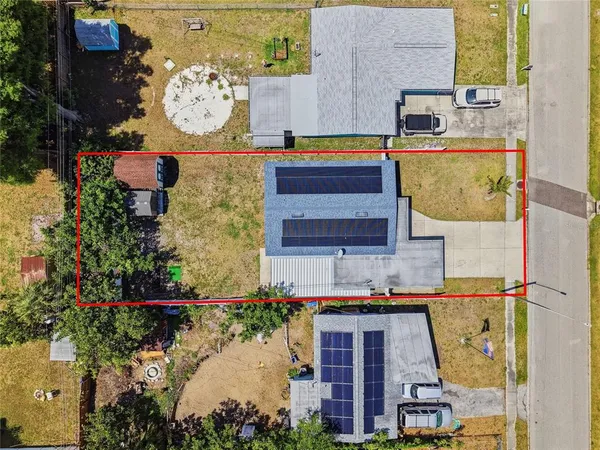 an aerial view of a house with garden space and sitting area