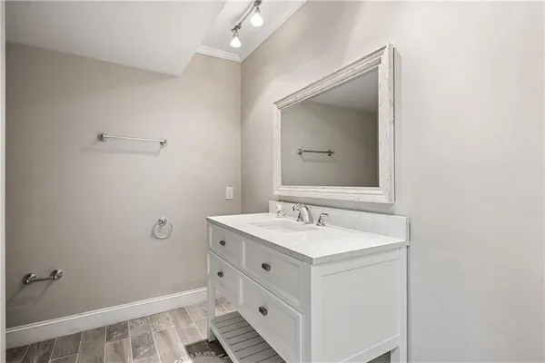a bathroom with a sink a vanity and a mirror