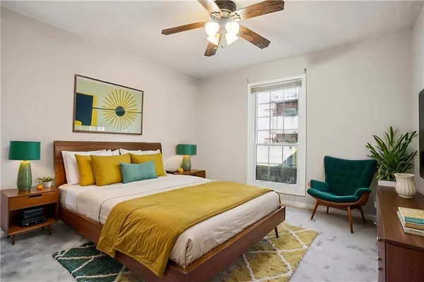a bedroom with a bed and a potted plant