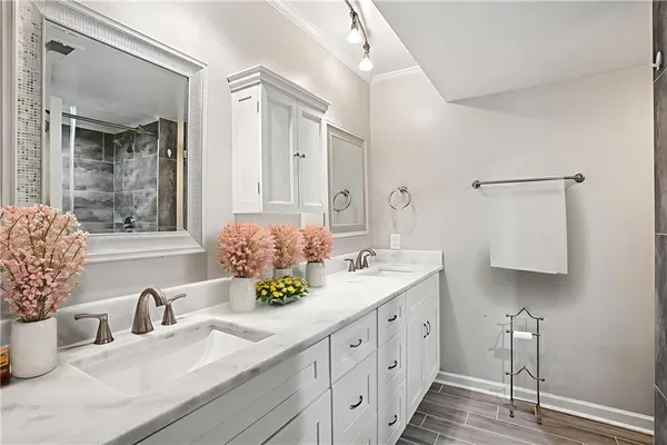a bathroom with a double vanity sink and a mirror