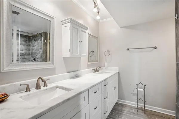 a bathroom with a granite countertop sink mirror and double