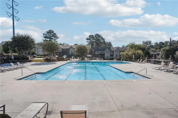 a view of a swimming pool with a yard