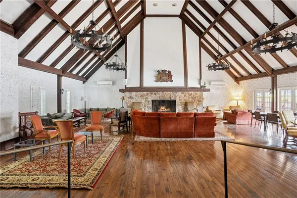 a living room with furniture a fireplace and a chandelier