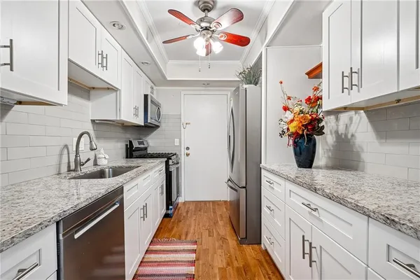a kitchen with stainless steel appliances granite countertop a sink stove and refrigerator