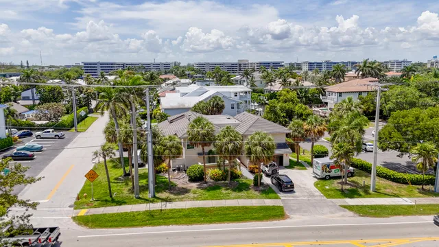 an aerial view of a house with a yard