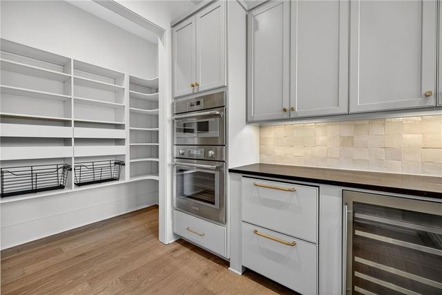a view of a livingroom with wooden floor and stairs