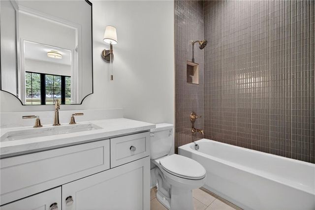 an aerial view of a tennis ground with a large trees
