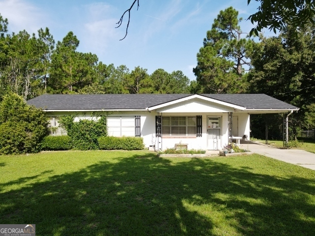 99 Overstreet Road Swainsboro, GA 30401 - Photo 1 of 1 a front view of a house with garden
