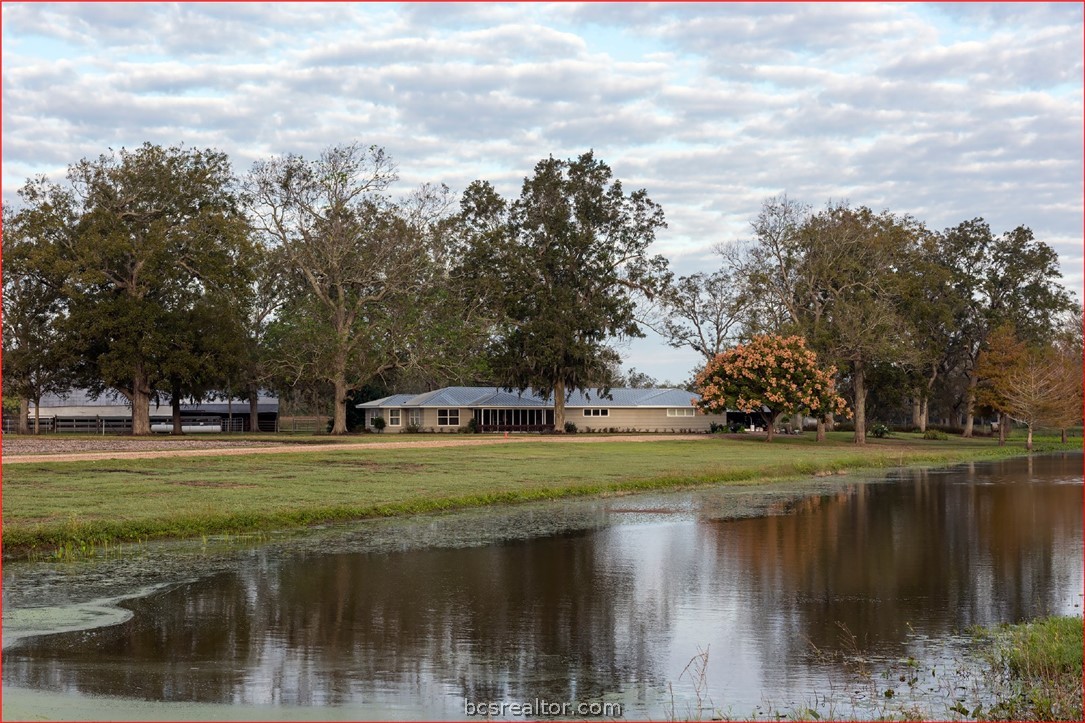 a view of a lake with a house in the background