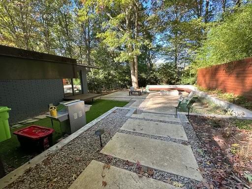 3322 Ocotea Street Raleigh, NC 27607 - Photo 19 of 34 a view of a backyard with tv