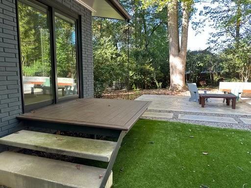 3322 Ocotea Street Raleigh, NC 27607 - Photo 20 of 34 a view of a patio with table and chairs and couches with wooden fence