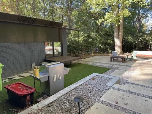 3322 Ocotea Street Raleigh, NC 27607 - Photo 27 of 34 a backyard of a house with outdoor seating