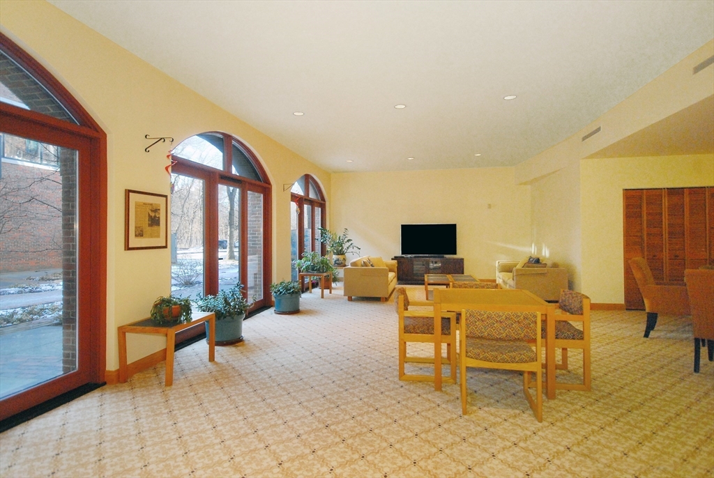 100 Keyes Road, Unit 220 Concord, MA 01742 - Photo 21 of 23 a living room with furniture and a flat screen tv