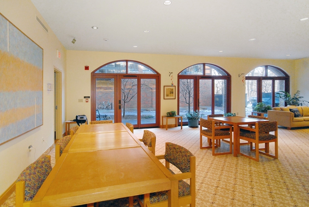 100 Keyes Road, Unit 220 Concord, MA 01742 - Photo 22 of 23 a living room with furniture fireplace and a large window