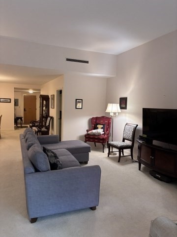 100 Keyes Road, Unit 220 Concord, MA 01742 - Photo 7 of 23 a living room with furniture and a flat screen tv