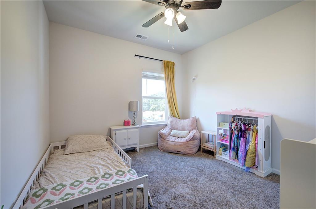402 Perth Drive Cartersville, GA 30121 - Photo 28 of 31 a bed room with a bed and a chandelier