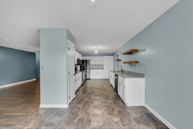 a view of a hallway with wooden cabinet and stairs