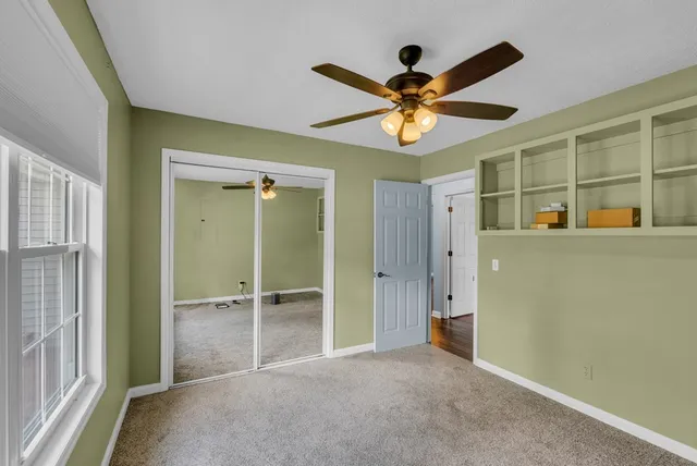 an empty room and chandelier fan