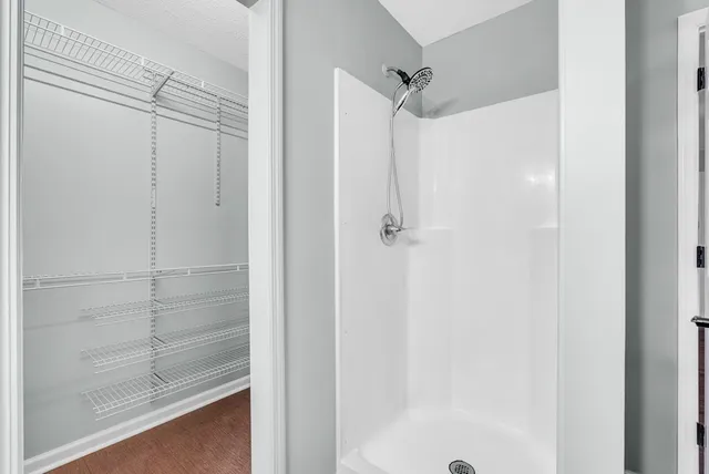 a bathroom with a glass shower door