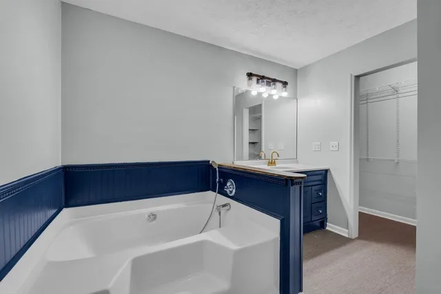 a bathroom with a bathtub and a sink