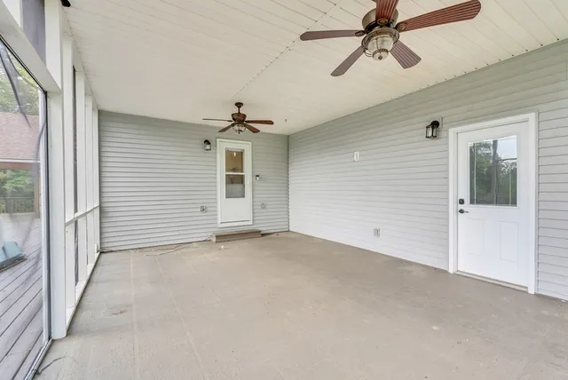 a view of a room with a ceiling fan and window