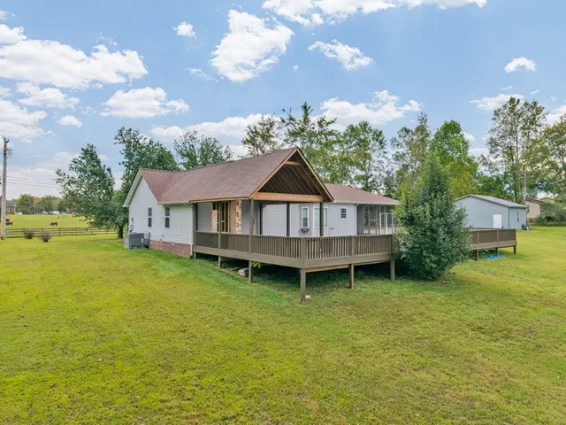 a backyard of a house with table and chairs