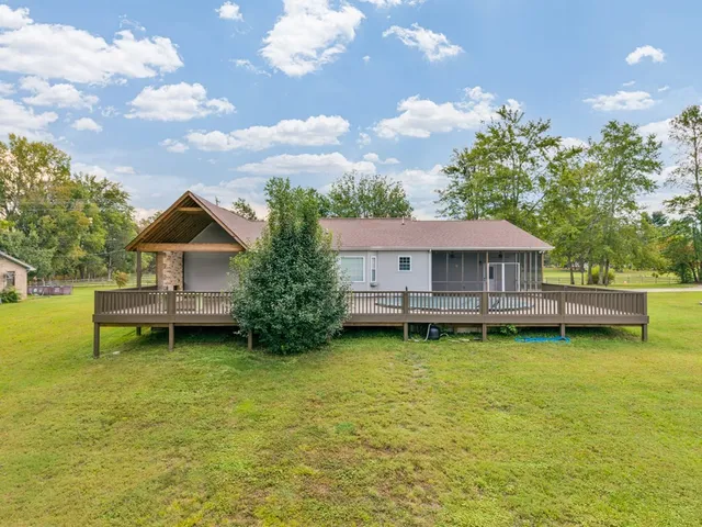 a view of a house with a backyard