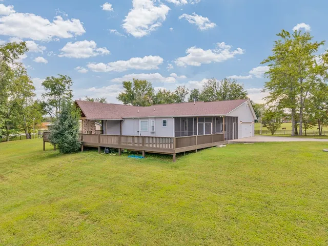 a view of a house with yard and tree s