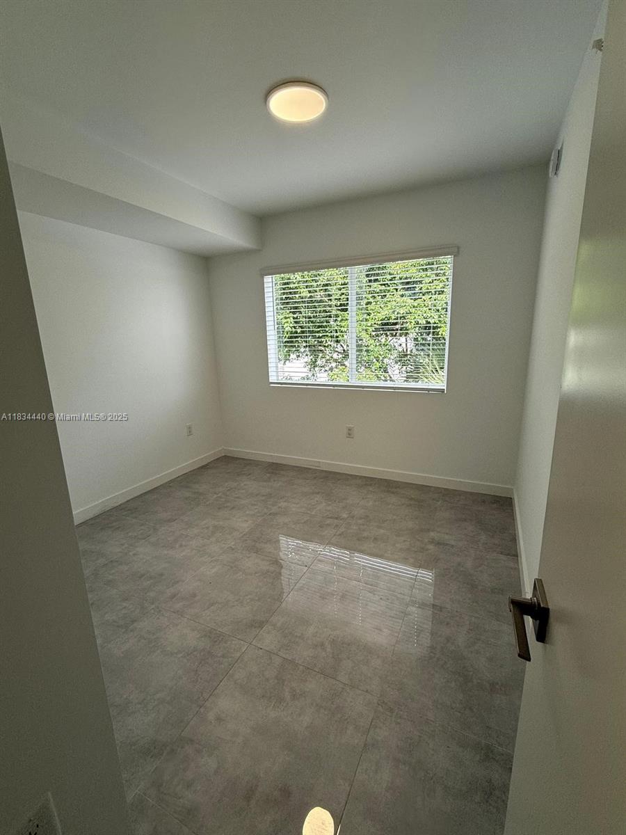 Golden Glades Miami, FL 33161 - Photo 5 of 11 an empty room with a window