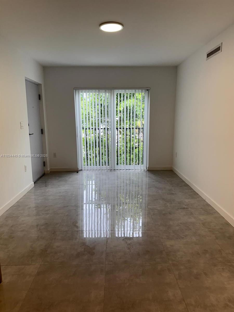 Golden Glades Miami, FL 33161 - Photo 6 of 11 an empty room with windows