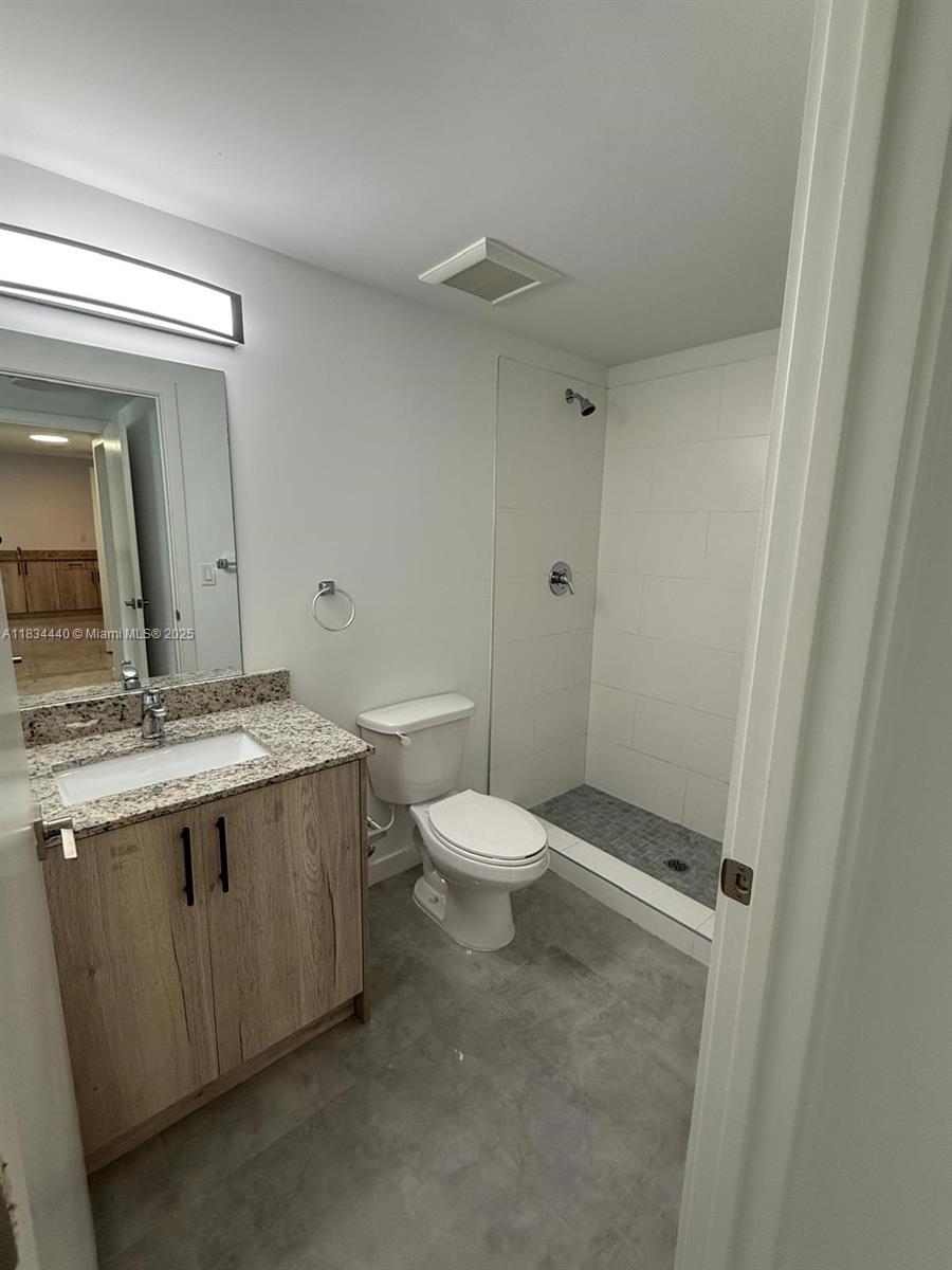 Golden Glades Miami, FL 33161 - Photo 7 of 11 a bathroom with a granite countertop toilet a sink and a mirror