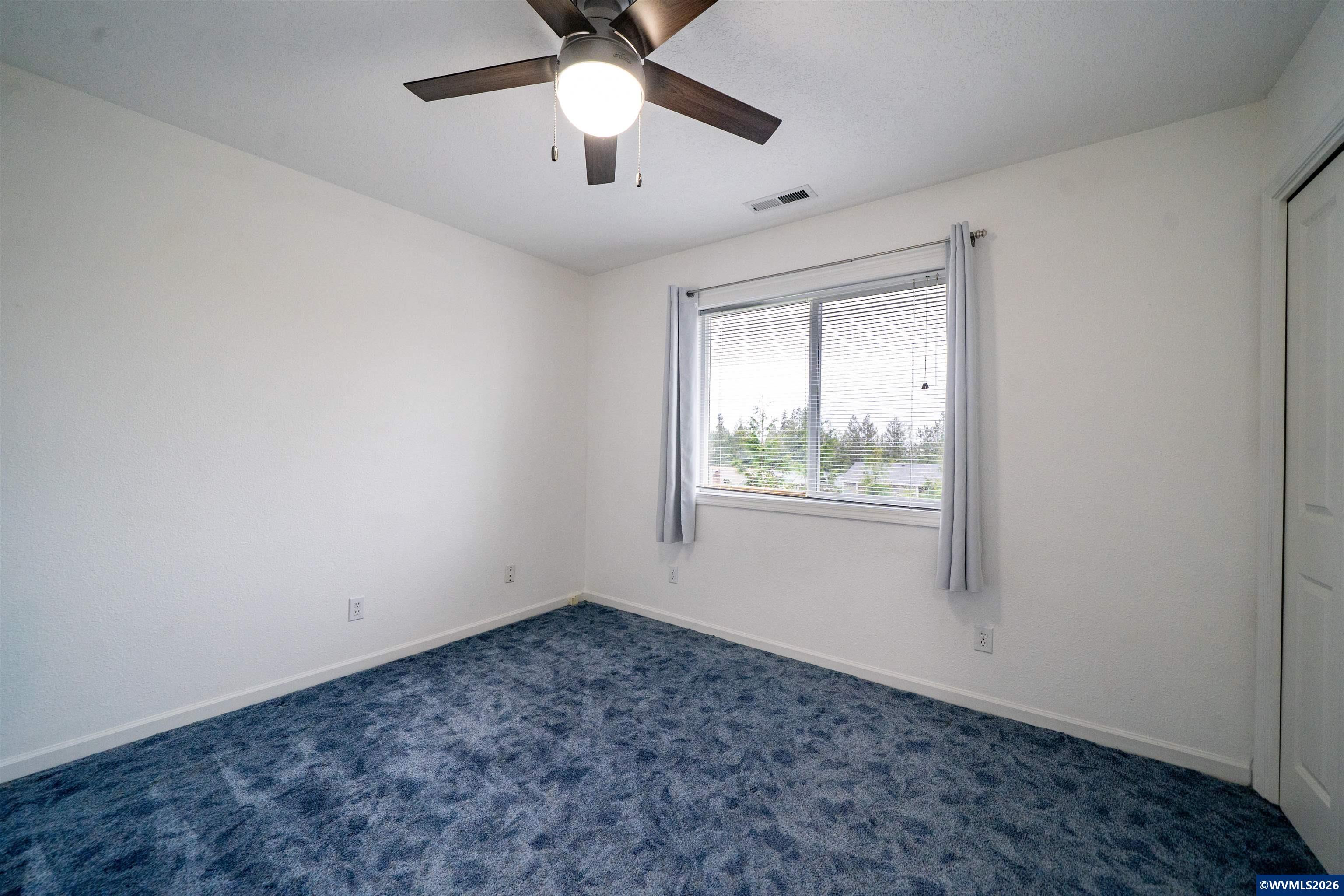 312 Southwest Cascade Meadow Drive Sublimity, OR 97385 - Photo 22 of 42 an empty room with a window and a fan