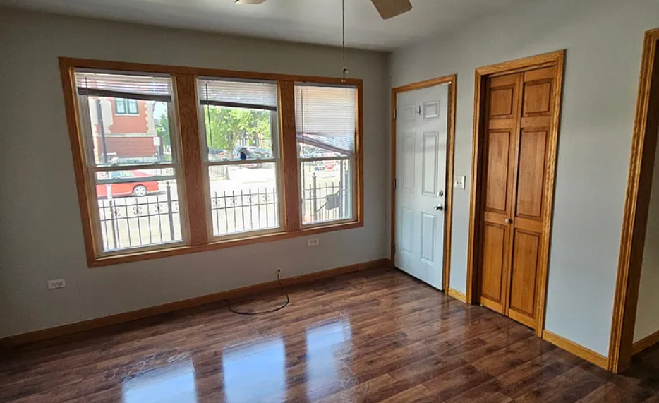 1019 West 18th Street Chicago, IL 60608 - Photo 11 of 26 an empty room with wooden floor and windows
